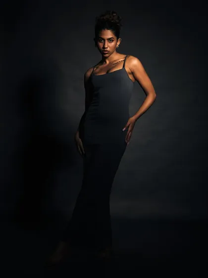 A full-length portrait using minimal light. This technique creates a dramatic, high-fashion image that is all about form and mood.