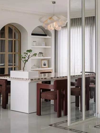 Welcome to Eden House, a 10,000-square-foot penthouse in Bengaluru designed to be a whimsical celebration of life. In this dining area, we played with form and light, creating a space that feels both grand and intimate, centered around a bespoke dining table that invites connection and conversation.