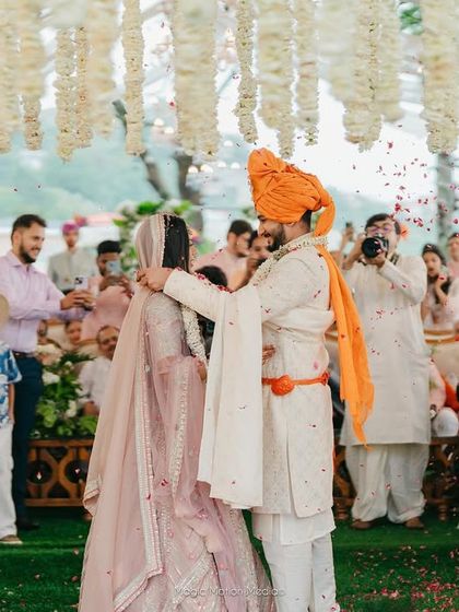 The Varmala ceremony, a moment of mutual respect and acceptance. The bride's look is soft and romantic, perfect for this heartfelt ritual.