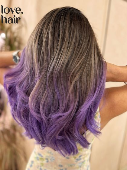 The full back view of the ash brown and purple balayage, showcasing the unique colour combination and the healthy, wavy hair.