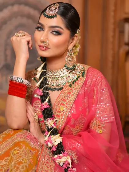 A seated portrait that captures the elegance of this bridal look. The makeup is soft yet defined, with a focus on creating a timeless and beautiful appearance.