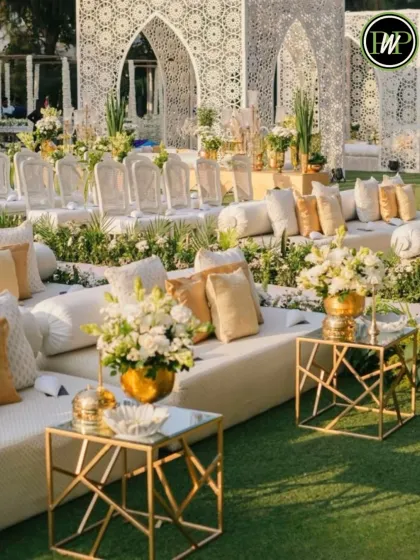 An elegant and luxurious outdoor seating arrangement in pristine white and gold. I believe guest comfort is key, and I design beautiful lounge areas where your loved ones can relax and celebrate in style.
