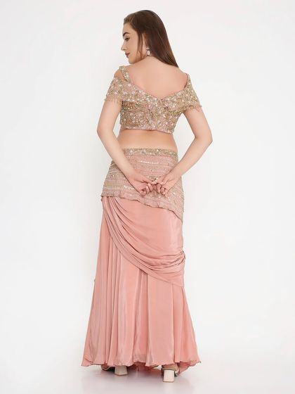 The back view of our peach draped outfit, showing the fully hand-worked details and the perfect custom fit. We ensure every angle is as stunning as the front.