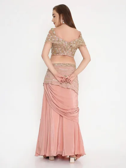 The back view of our peach draped outfit, showing the fully hand-worked details and the perfect custom fit. We ensure every angle is as stunning as the front.