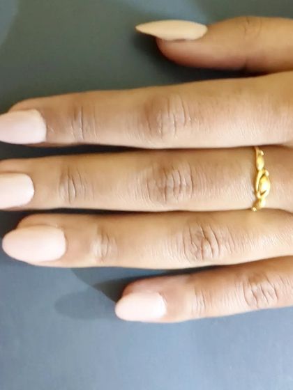 Another look at these perfect almond-shaped nails in a solid nude color. The shape elongates the fingers, and the high-gloss top coat gives them a durable, salon-quality shine.