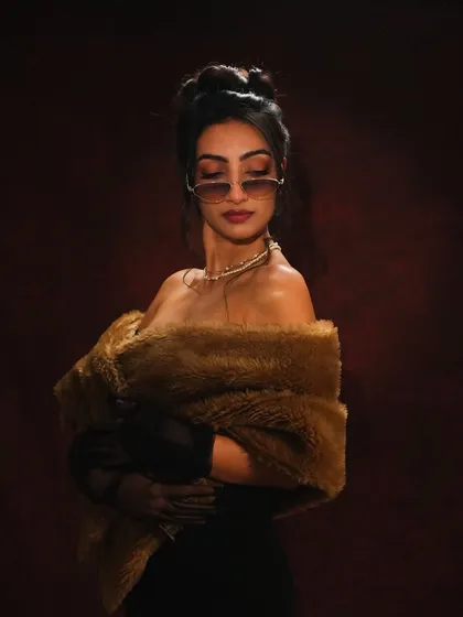 Adding a modern twist with sunglasses. This shot combines vintage elements like the fur stole and pearl necklace with a cool, contemporary attitude, and the makeup bridges the gap perfectly.