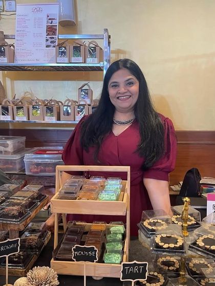 A solo shot of me at my stall, surrounded by all the desserts I lovingly prepared. Seeing it all come together at an event is one of the best feelings.