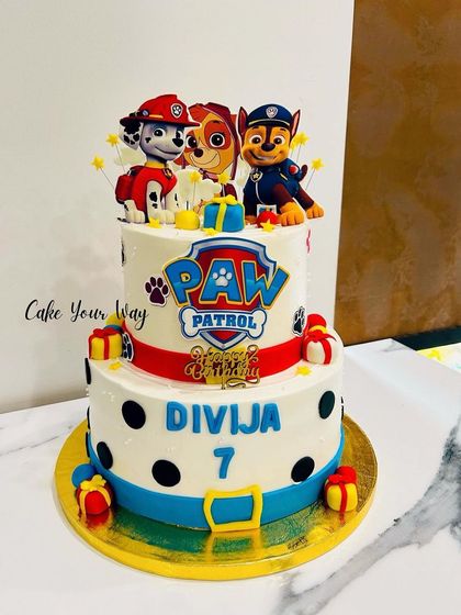 Adventure awaits with this two-tier Paw Patrol cake, featuring polka dots and the brave pup team.