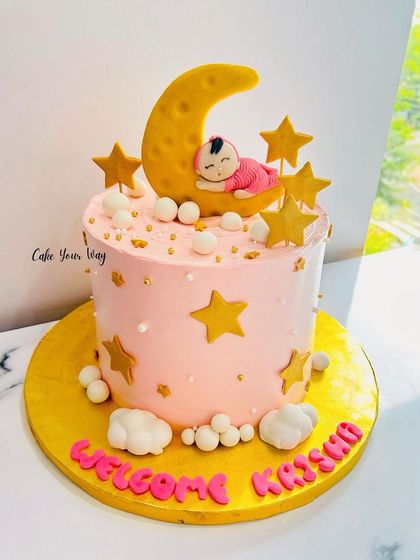 A welcome cake for a cute little angel, featuring a baby sleeping on the moon.
