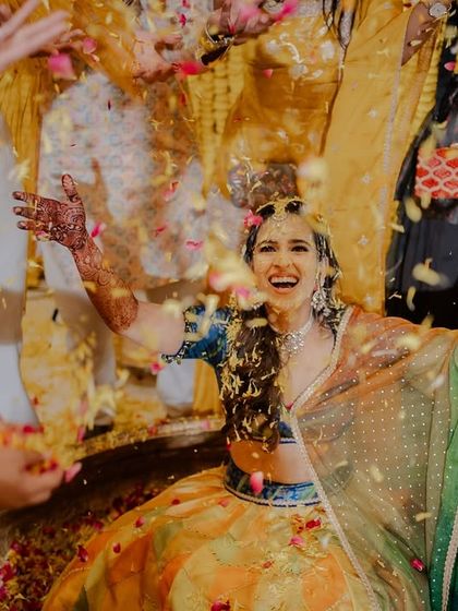 Being showered with love and petals! I love capturing the bride's expression of pure delight during her Haldi ceremony.