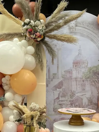 A close-up of our Bridgerton-inspired first birthday, showing the mix of pampas grass, dried florals, and a vintage-style printed backdrop.
