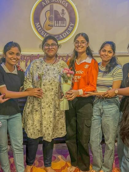 Our adult students are a huge part of our musical family. Here they are celebrating a birthday with flowers and smiles after our class session.