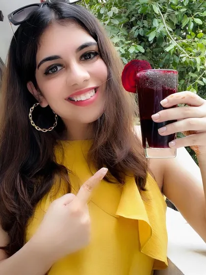Here I am with my favorite BBC (Beetroot, Berries, and Carrots) juice! This is my secret weapon for getting that natural blush on your cheeks without any makeup. It's delicious, easy to make, and so good for your skin.