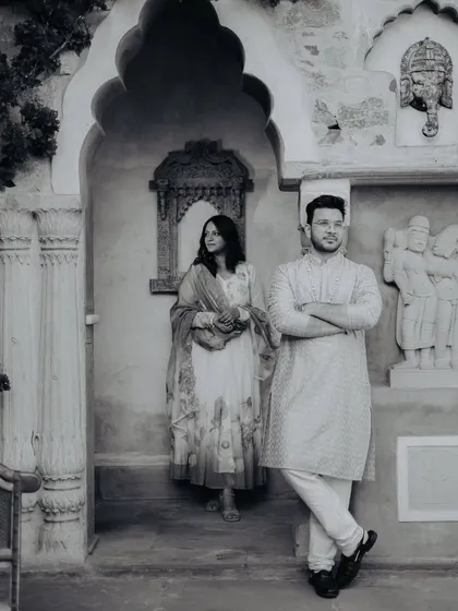 A timeless black and white portrait against a rustic, traditional Indian backdrop. Monochrome photos often bring out the emotion and texture in a scene.
