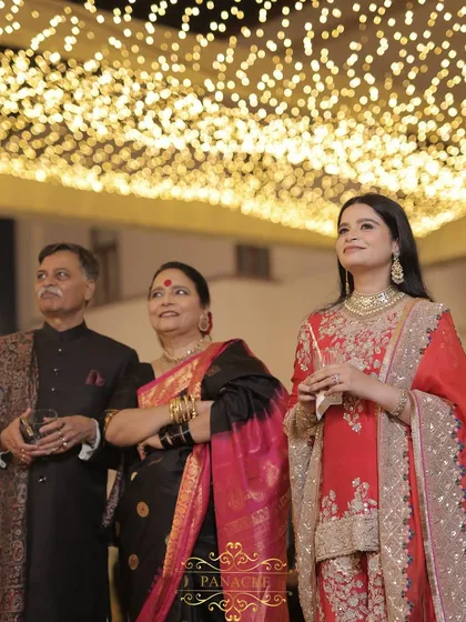The bride and her parents listening to the speeches, their faces filled with emotion.