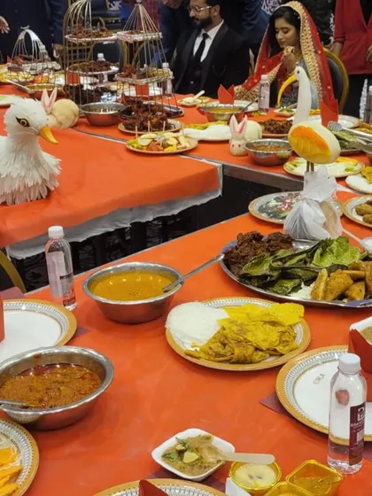 This is what a true feast looks like. A table laden with a variety of dishes, from rich curries and assorted appetizers to fresh salads and our special bird-cage platters, ready for a memorable *valima dawat*.