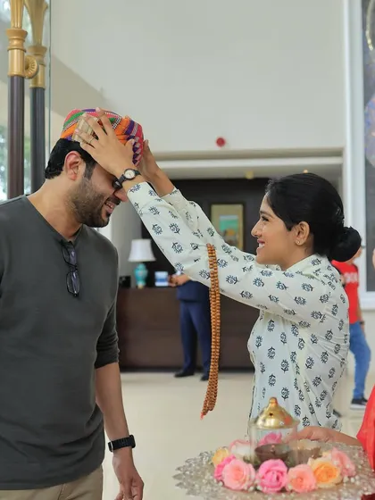 A warm, traditional welcome for guests arriving for a destination wedding. This gesture of respect and hospitality, complete with a traditional tilak and headwear, makes guests feel cherished from the moment they arrive.