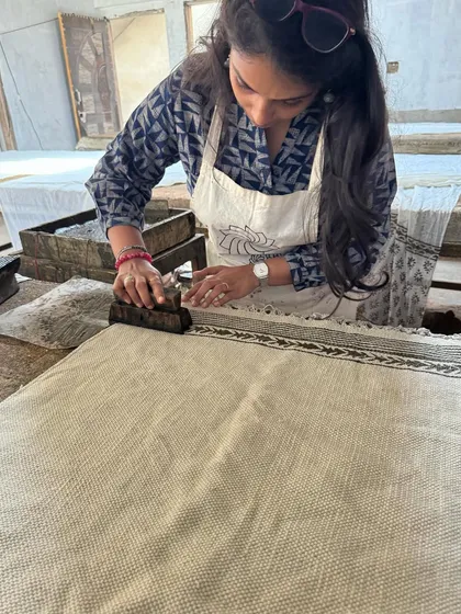 Here I am learning the Dabu printing process, applying the mud-resist paste with a block before the fabric is dyed. It's a fascinating and complex technique that yields beautiful results.