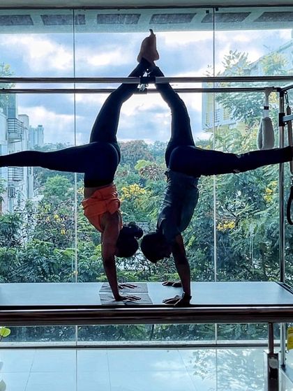 Where strength meets grace. This synchronized handstand on the Cadillac is a beautiful display of balance and partnership.