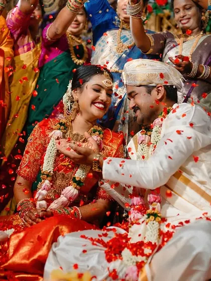 This is what pure joy looks like. We love capturing the peak moments of a South Indian wedding ceremony, like this traditional akshatharopanam ritual, where the couple is showered with blessings, rice, and flower petals.