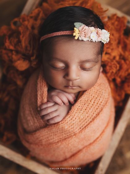 Bonnet or tiara? This little one is wearing a beautiful floral tiara with a soft orange wrap, showing how we can style the session to your taste.