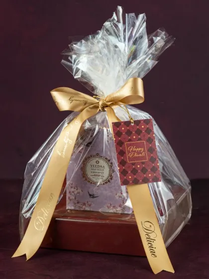 This Diwali hamper is a perfect gesture of love, featuring our handmade assorted dry fruit chocolates and a beautiful scented candle, all wrapped up for the occasion.