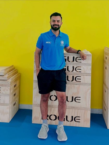 Posing with plyometric boxes at a high-performance coaching course. Investing in my own education ensures that the training programs I design are based on the most current and effective methods.