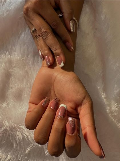 A classic French manicure with a glittery twist. This design features a soft, sparkling glitter base that adds a touch of glamour to the timeless look.