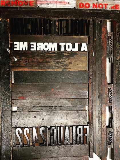 A look at the letterpress setup, with the woodblock type locked in place for printing the poster's text.