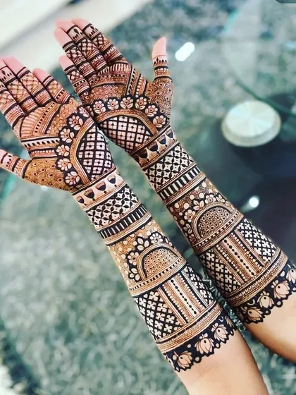 A classic and elegant design with geometric and floral bands. This style is perfect for someone who wants a full-hand mehendi that is not too heavy on figures.