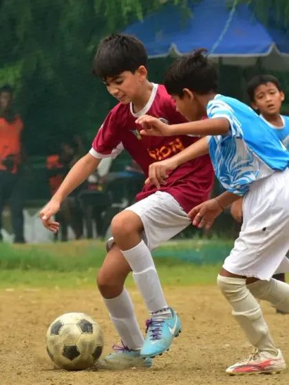 All the training and hard work comes together on match day. This action shot from a tournament shows one of my players skillfully maneuvering the ball against two opponents, demonstrating the confidence and control we practice relentlessly.