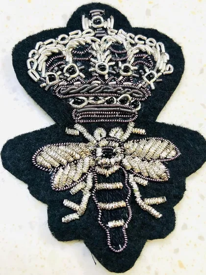 A close-up of the silver crowned bee patch, highlighting the detailed zari and beadwork. This appliqué can be sewn onto a shirt, blazer, or bag to instantly upgrade its style.
