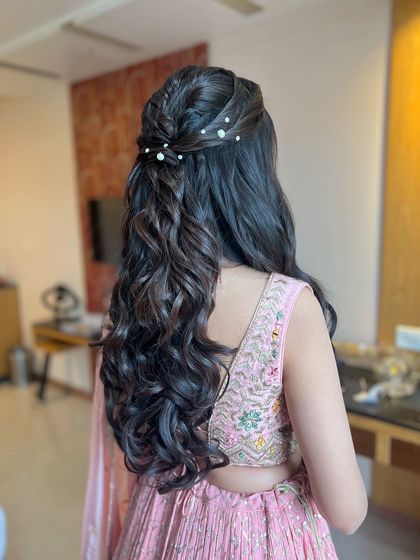 A classic half-updo with a braided detail and scattered pearls, a pretty and popular choice.