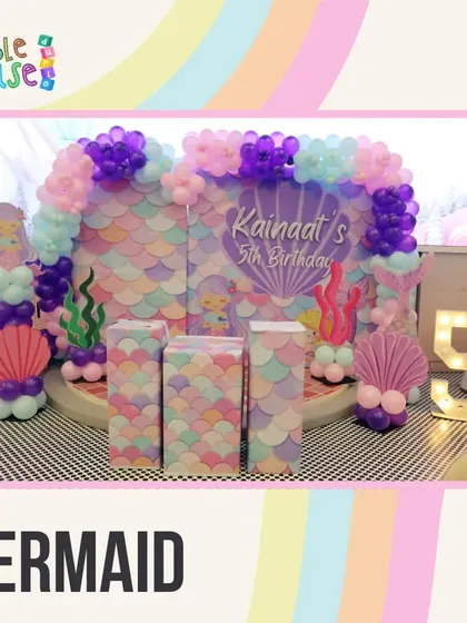 Our Mermaid theme features a beautiful backdrop of purple and pink scales, seashell balloon pillars, and an underwater feel.