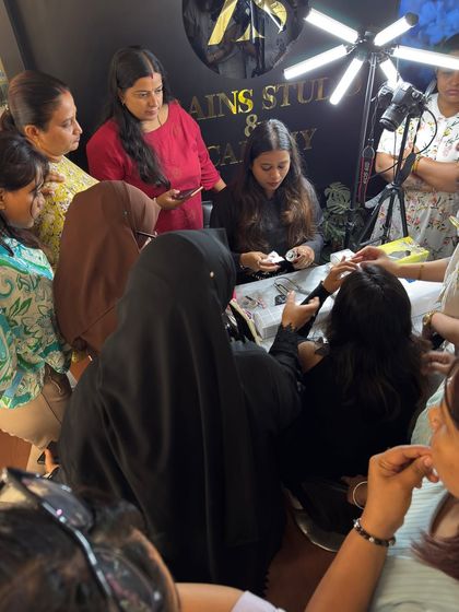 A packed classroom for our nail art course. Students gather around to watch a live demonstration, learning the intricate details of professional nail design.