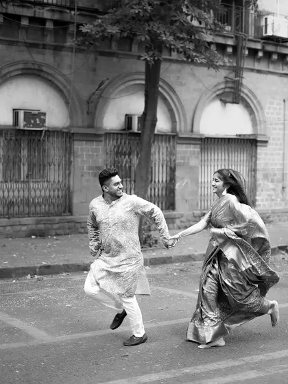 A playful, spontaneous moment captured in black and white against the classic architecture of Mumbai. This pre-wedding photo shows our ability to find romance and fun in urban landscapes, telling a story that feels both timeless and modern.
