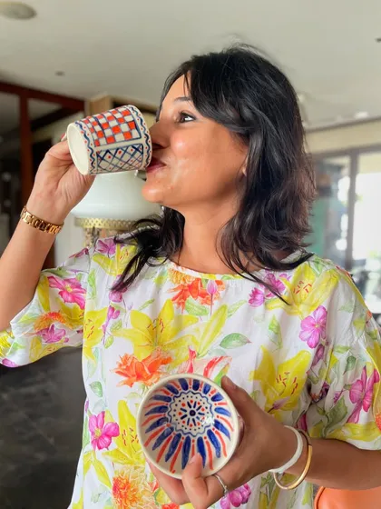The best part of making your own mug? Getting to drink your chai from it! This student is enjoying her beautiful, hand-painted creation.