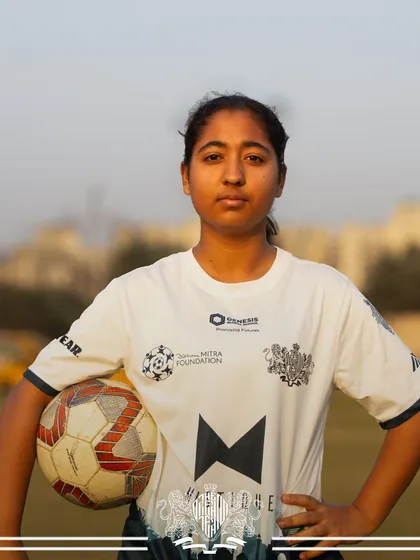 Ready for the game. A player from our women's team, ball in hand, focused on the match ahead.