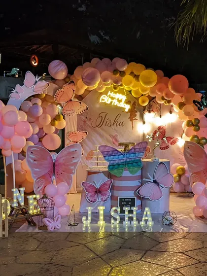 This enchanting butterfly theme was perfect for a first birthday party. We used a soft pastel balloon arch, large butterfly cutouts, and marquee lights with the birthday girl's name to create a whimsical garden feel.