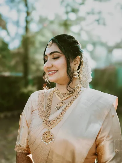 A serene close-up. Her skin looks flawless and dewy, a testament to the detailed skin prep and careful application that goes into every bridal look.