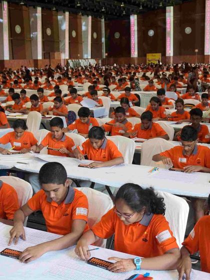 Another view of a competition in progress. Students are using a combination of the physical abacus and mental visualization to solve problems.