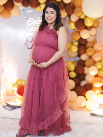 Look and feel your best at your baby shower. This client is glowing in our wine-colored ruffled gown, a comfortable and elegant choice for any celebration. The soft tulle and flattering design make it a party favorite.