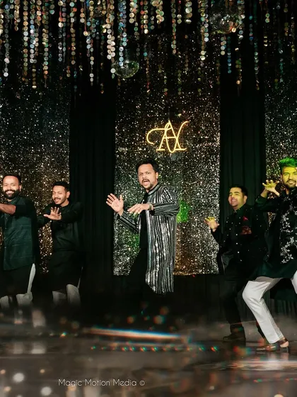 The groom and his backup dancers in a high-energy moment from his solo performance. We love creating these dynamic, synchronized routines that look amazing on stage.