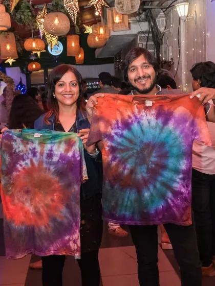 I love offering a variety of creative activities, like this vibrant tie-dye workshop. This couple is showing off the matching custom t-shirts they designed together, each a unique swirl of colors and a wearable piece of art.