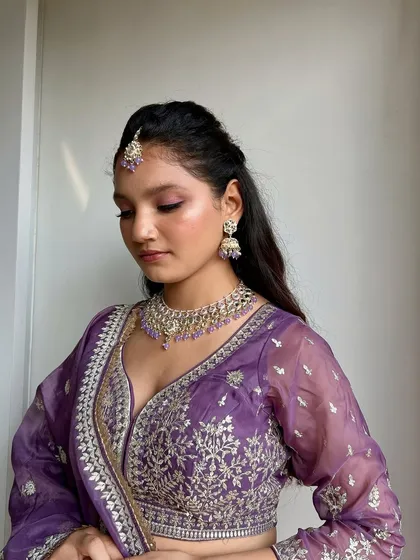 A quiet moment captured indoors, showing how the soft glam makeup looks just as beautiful away from the bright outdoor lights.