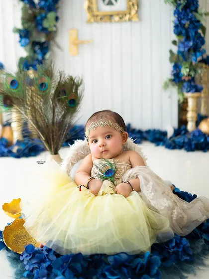 This baby girl dressed as Radha looks absolutely precious in her yellow dress and peacock feather.