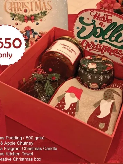 Share the warmth of the season with my special Christmas gift hamper. It’s filled with homemade goodness, including a traditional Christmas pudding, my signature tomato and apple chutney, a festive candle, and a cute kitchen towel, all packed in a beautiful decorative box.