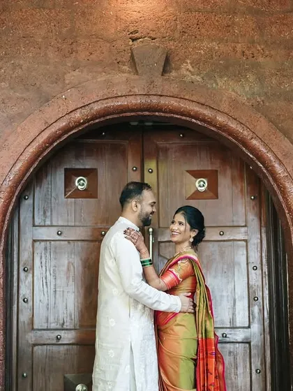 Framed by a rustic doorway, the couple shares an intimate glance. We use architectural elements to create beautifully composed, story-driven portraits.