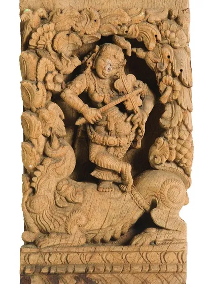Our work extends beyond canvases to three-dimensional heritage objects. This intricately carved wooden panel, depicting a celestial musician, is one of over 200 pieces from a 100-year-old temple chariot that we painstakingly documented and restored over two years.