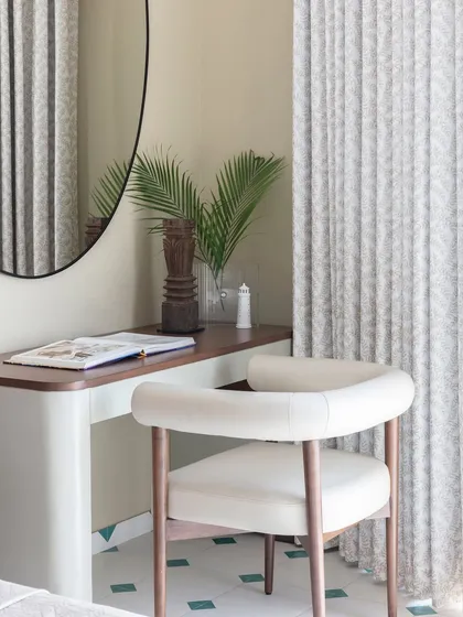 Amidst the tranquil sanctuary of this bedroom lies a wondrous alcove. I designed this cozy study corner to be a space where creativity blossoms and dreams take flight, anchored by a simple desk and a comfortable chair.